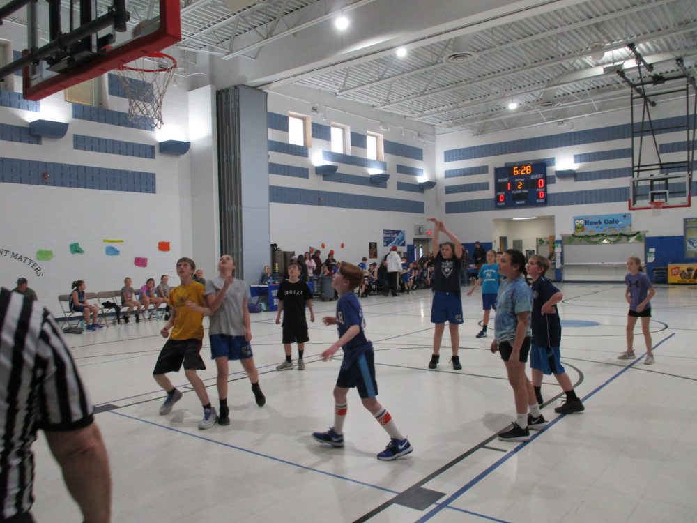 Youth basketball game in gymnasium