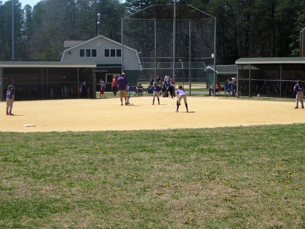 Baseball game on the field in sunshine